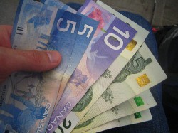 hand holding canadian money